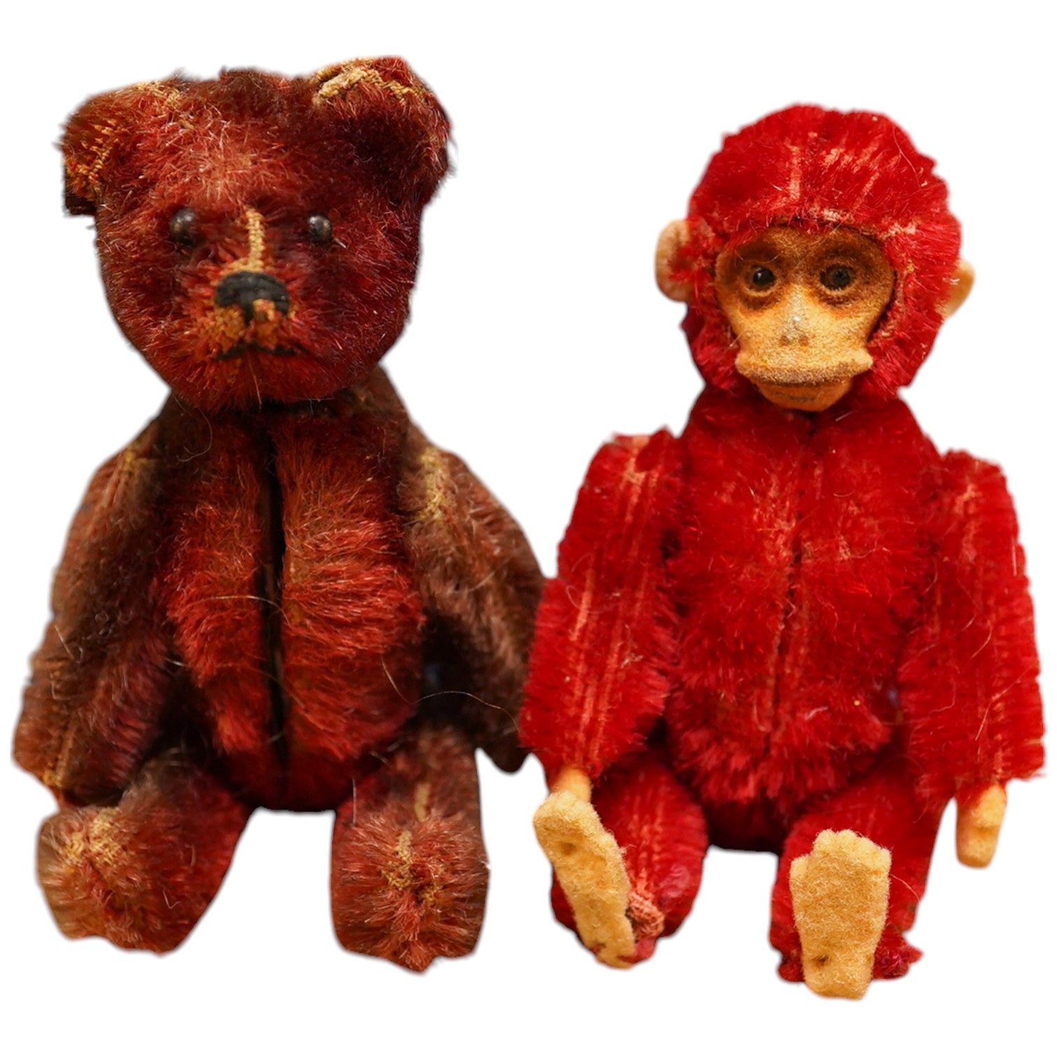 A red Schuco monkey compact with some slight wear to back of legs, otherwise in good unfaded condition, c1920, height 9cm, together with a Schuco Teddy manicure set in good condition, red mohair faded, height 9cm, c.1920